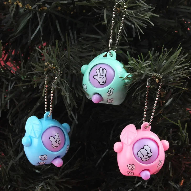 Three pastel colored guessing game eggs in various shades of blue and pink hanging on a dark green pine branch
