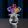 A crystal rose decorative flower arrangement featuring colorful, faceted glass petals on a clear base.