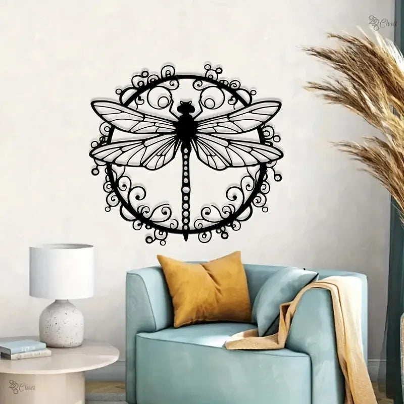 Elegant black dragonfly metal wall art displayed on a light blue sofa.