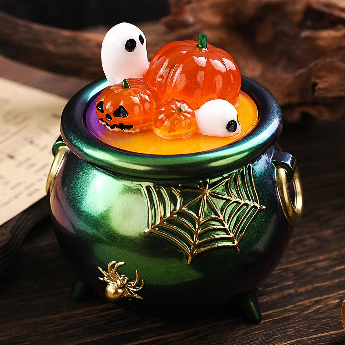 A green ceramic jar filled with orange and white silicone Halloween pumpkin molds for candles and craft projects