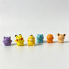 A set of six colorful kawaii anime fantasy creature mini figurines in various colors and poses arranged horizontally on a whi