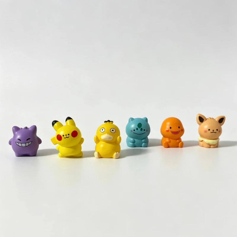 A set of six colorful kawaii anime fantasy creature mini figurines in various colors and poses arranged horizontally on a whi