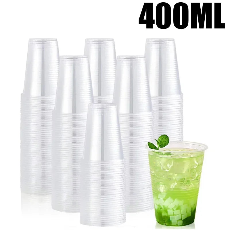 A set of clear 400ml disposable plastic cups with straws and a glass of green liquid.