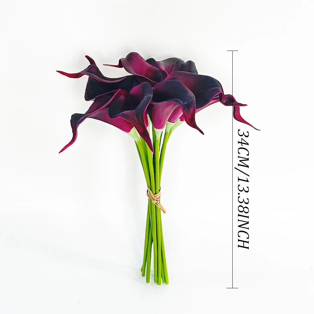 A bouquet of six deep purple artificial calla lilies with green stems and a measurement scale.