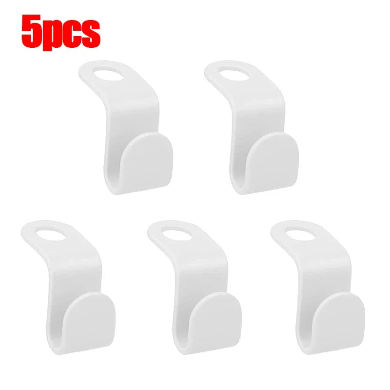 A set of five white space-saving hanger connector hooks for organizing and hanging items.