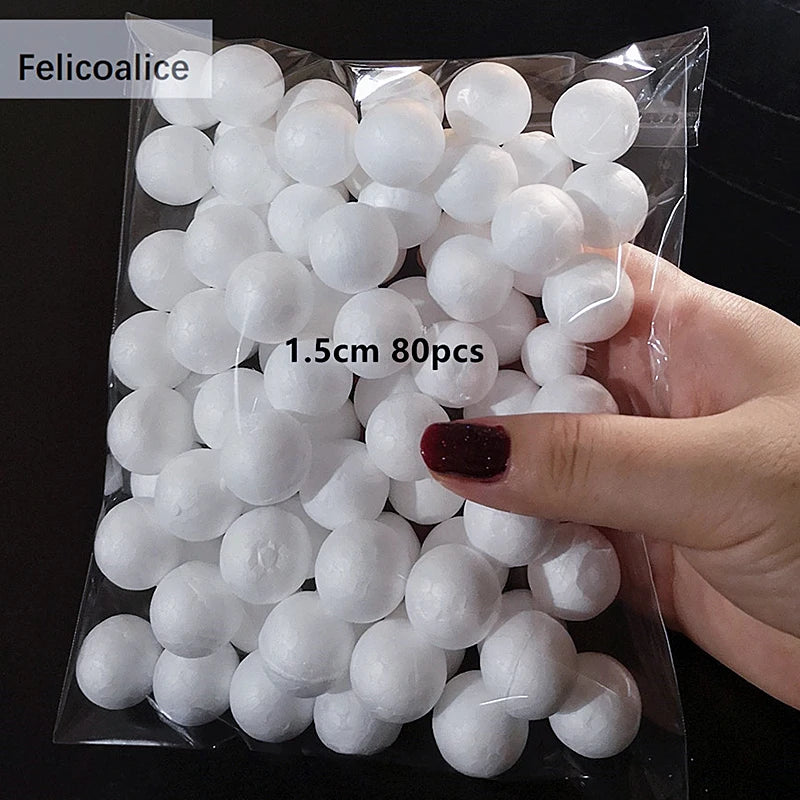 A hand holds a clear plastic bag filled with white polystyrene foam balls for crafting and decorating.