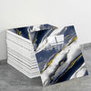 Rolls of faux marble 3D self-adhesive wall tiles featuring white and gold veining on a dark blue background