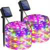 A bundle of colorful LED string lights is displayed next to a solar panel light fixture.