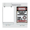 A vintage metal tin sign with a warning label that reads You are no longer trespassing you are a target
