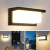 A modern rectangular LED wall sconce with a black frame and bright white light mounted on a light gray wall.