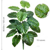 A vibrant artificial Monstera plant featuring large, glossy green silk leaves.