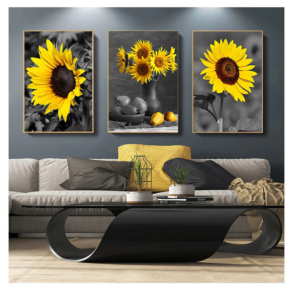 Three framed vintage sunflower canvas wall art prints displayed on a gray wall above a modern coffee table.