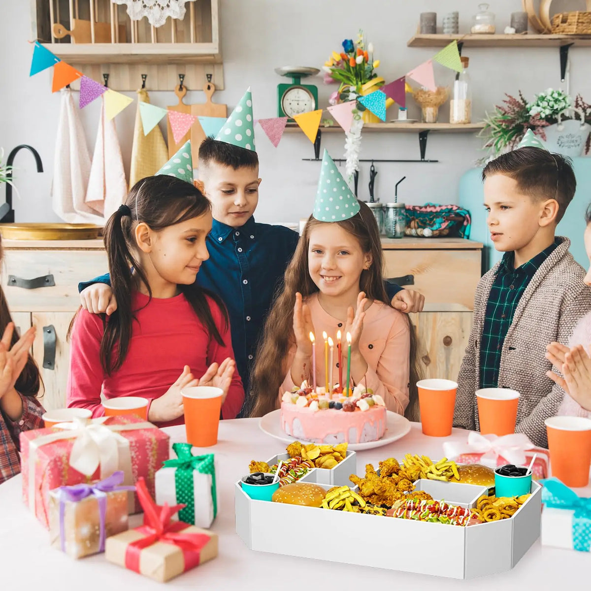 A white tray filled with colorful party snacks and candles for a number six birthday celebration.