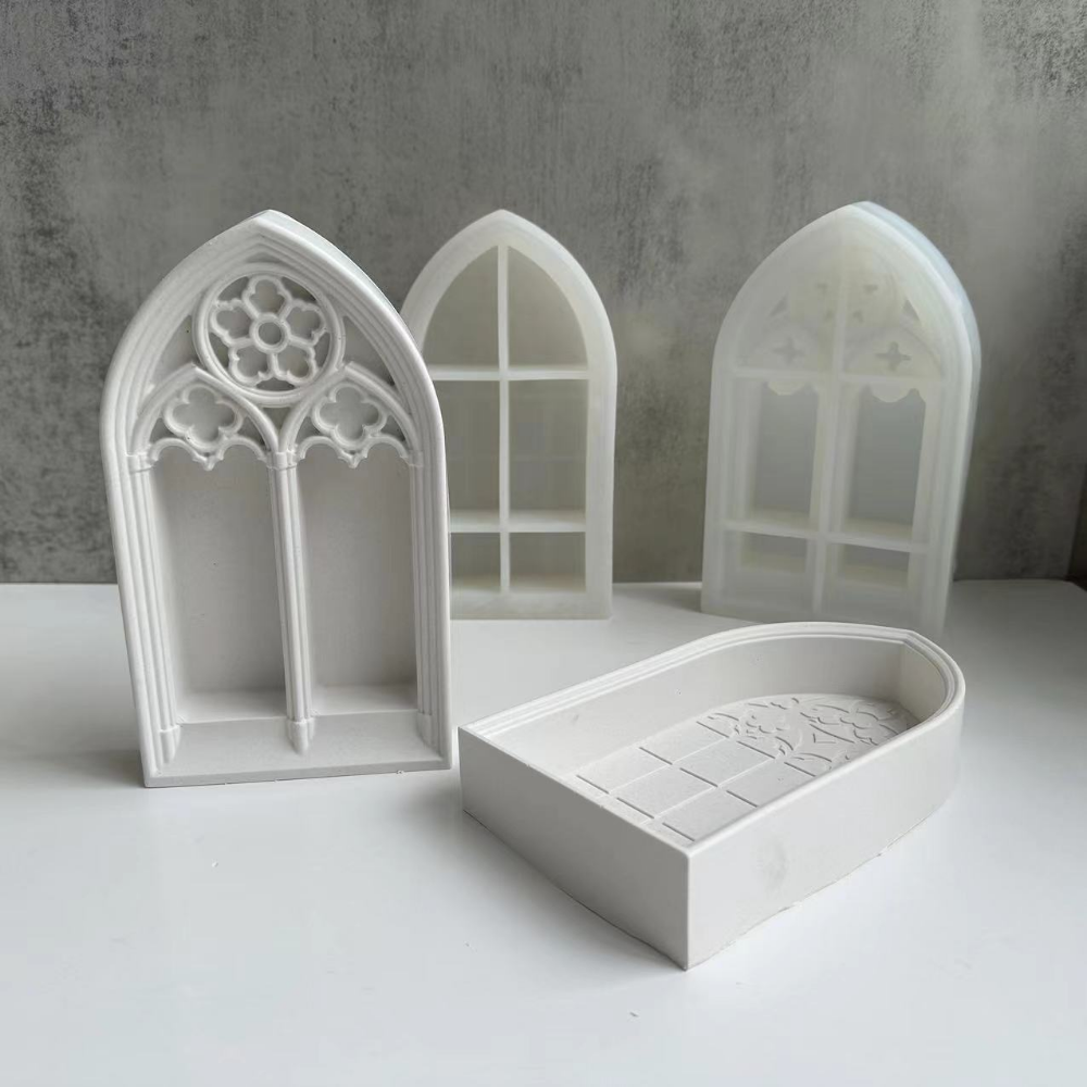 White silicone molds shaped like gothic church windows for crafting resin and plaster
