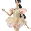 A handmade doll dress gown featuring yellow and pink floral patterns with ruffled sleeves and glitter trim.