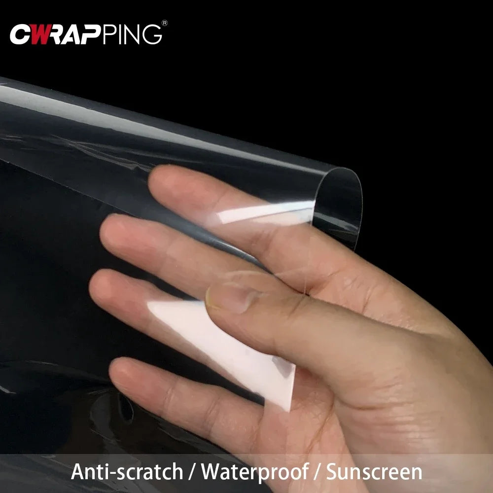 A hand is applying a clear film to a dark surface, demonstrating the anti-scratch and waterproof properties of the furniture 