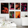 A gallery wall featuring four vintage posters titled Love Is Rock, TV Girl, and French Exit.