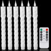 A set of six white tapered flameless LED taper candles standing upright.