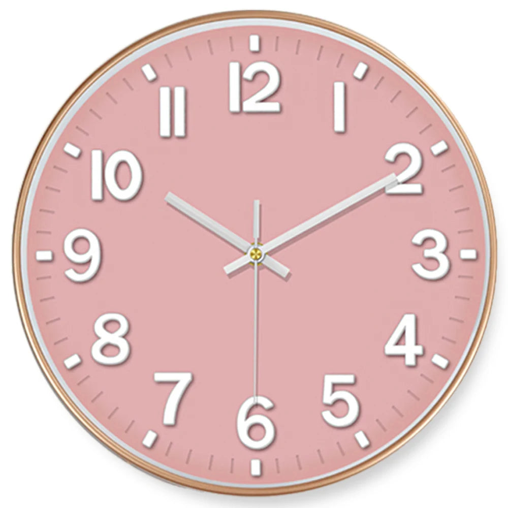 A pink minimalist wall clock face showing the time, with gold accents and white numbers.