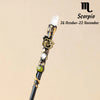 A natural clear quartz zodiac crystal wand with gold accents, displayed against a neutral background.