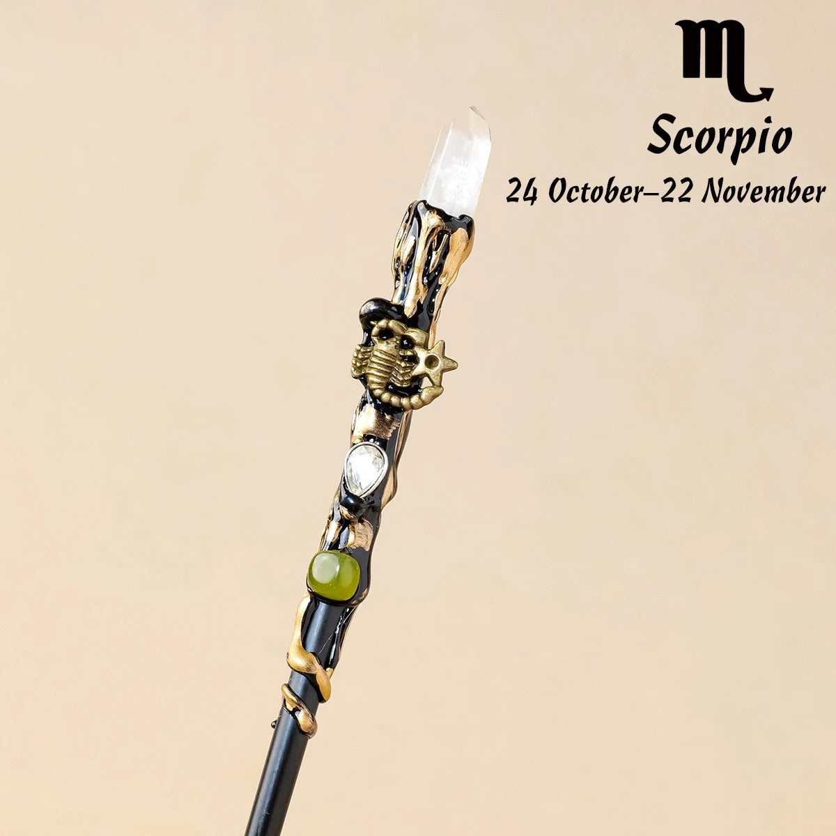 A natural clear quartz zodiac crystal wand with gold accents, displayed against a neutral background.