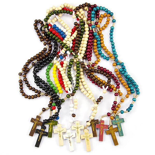 A tangled necklace of wooden rosary beads and Jesus crucifix pendants in various colors