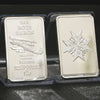 A silver bullion bar replica featuring an eagle design and text, packaged in clear plastic.