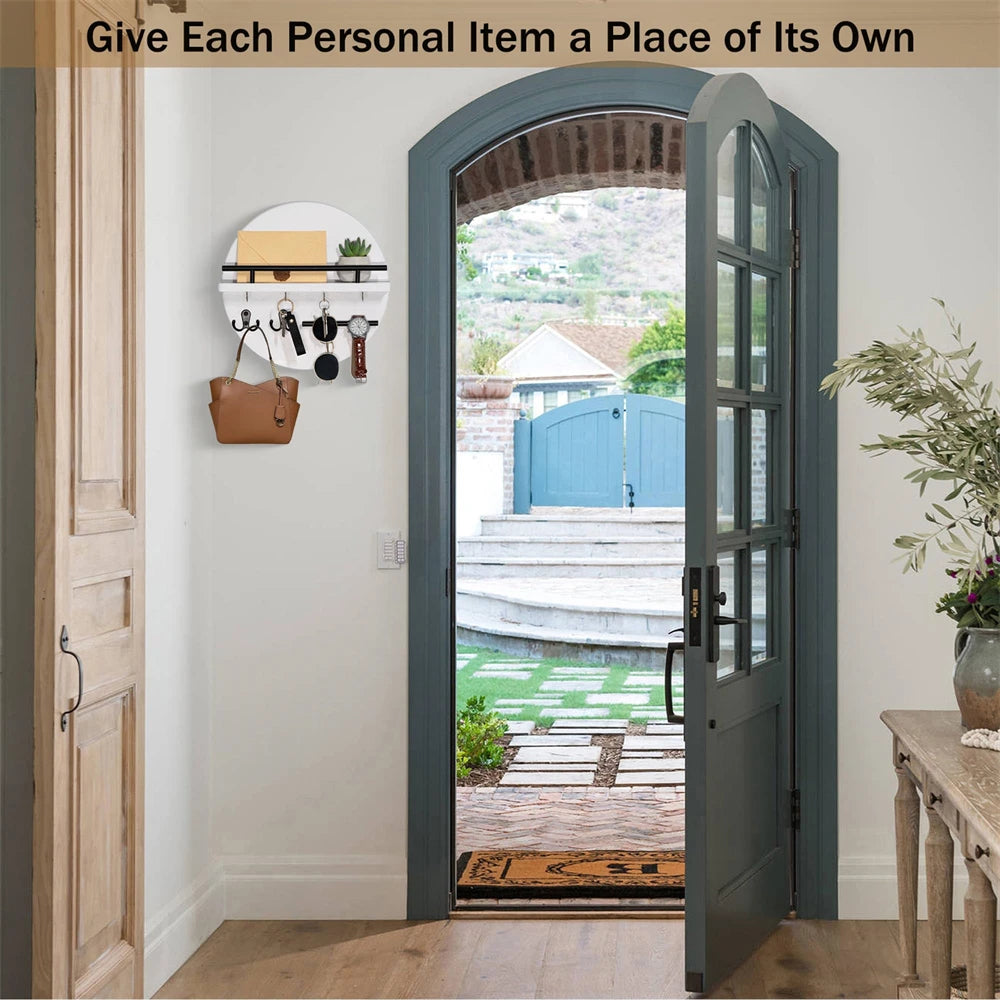 A circular wooden wall key holder with a shelf is mounted on a white wall inside a light blue door frame.