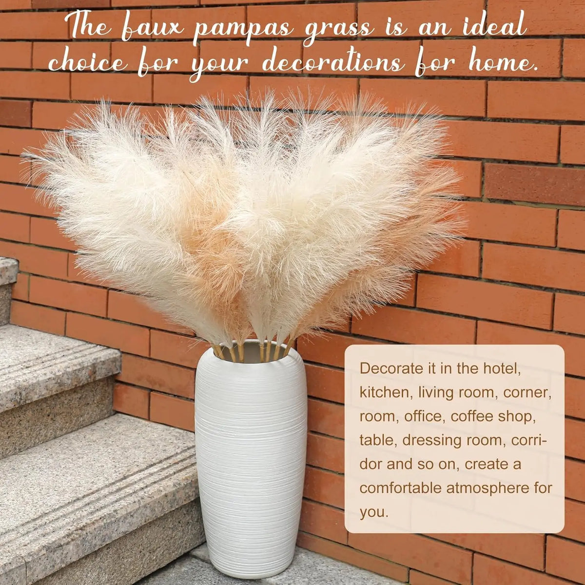 A large bundle of fluffy beige pampas grass stems displayed in a white vase against a brick wall.