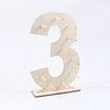 A light wood number display stand shaped like the number three, used for desserts.