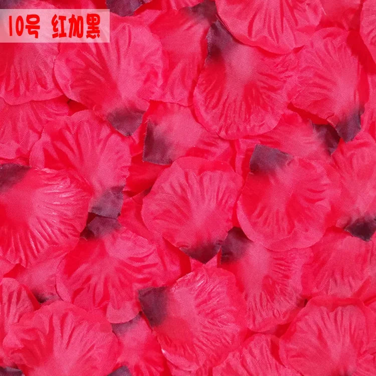 Close-up of vibrant pink and red silk rose petals scattered for weddings and events