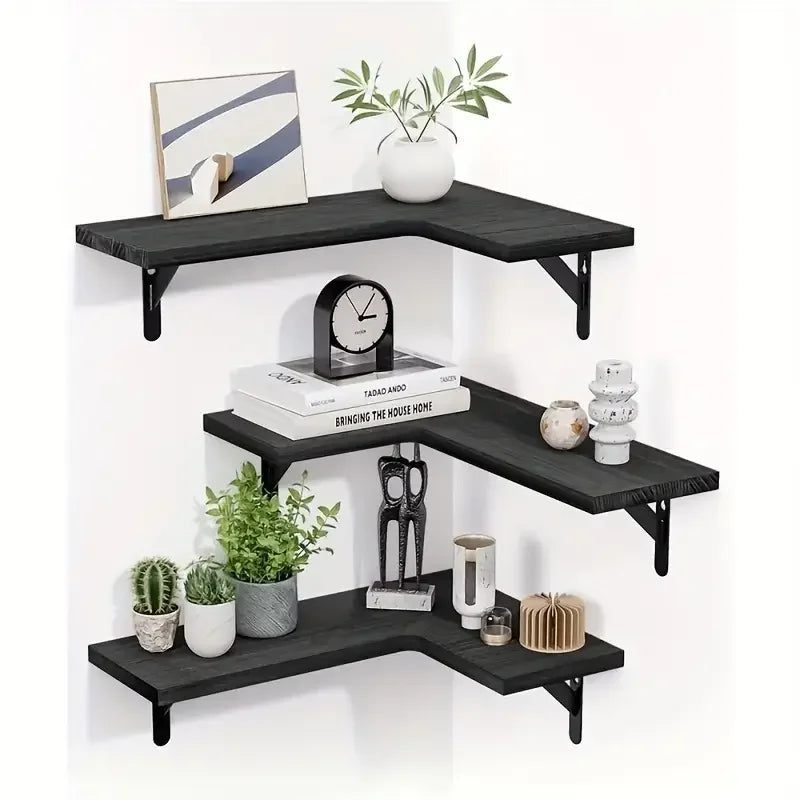 Black wood floating corner shelves displaying plants and decorative items.