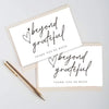A set of two white thank you cards with handwritten script saying beyond grateful and thank you so much