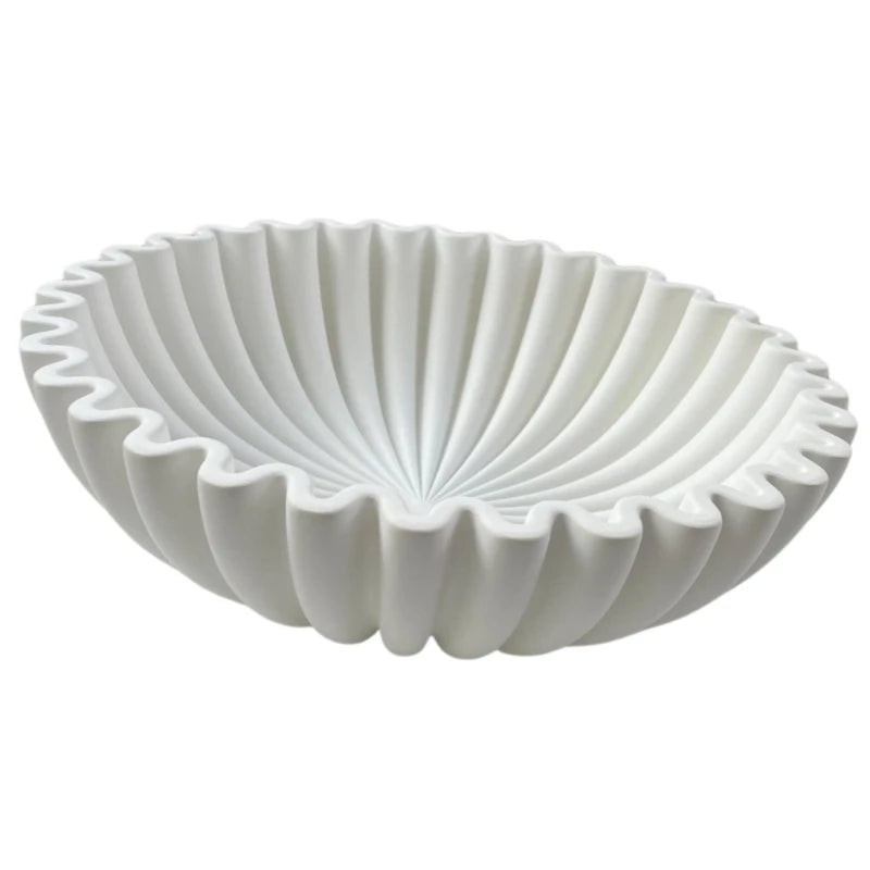 A white modern ruffle scalloped decorative bowl with deeply fluted sides.