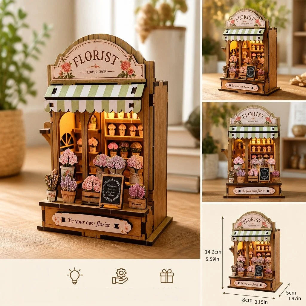 Wooden florist shop display box with a striped awning and various floral arrangements.
