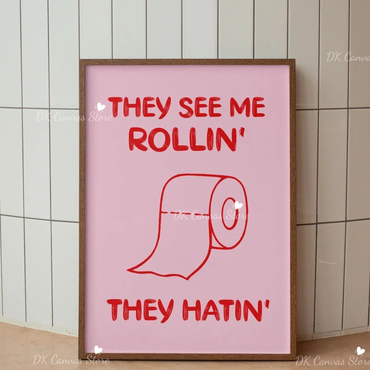 Pink canvas wall art print with text saying They see me rollin' and They hatin' featuring a rolled-up scroll graphic