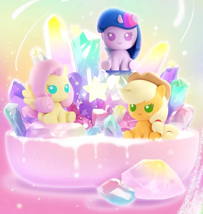 A collection of My Little Pony Magic Bottle collectible figurines featuring a purple pony, a yellow pony, and various sparkli