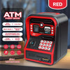 Une tirelire distributeur automatique rouge avec reconnaissance faciale et clavier sur une surface en bois.