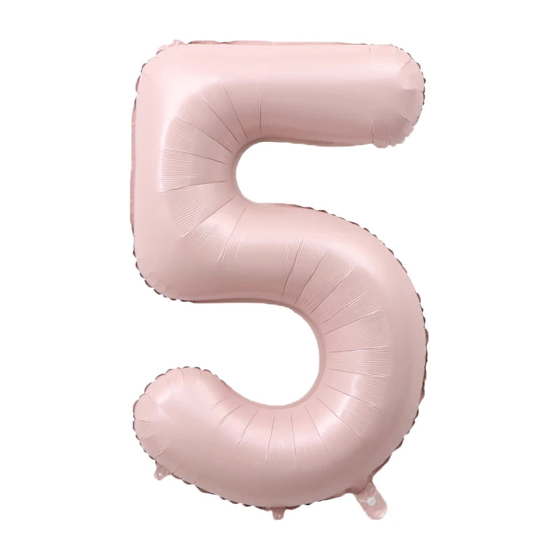 A pink foil number balloon shaped like the numeral five.