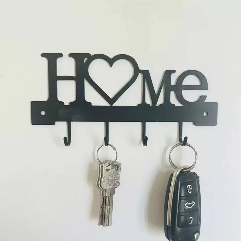 Black letter-shaped metal wall key holder with four hooks shaped like H O M E