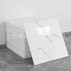 A rectangular slab of white marble with gray veining, displayed on a gray floor.