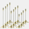 A set of twelve elegant gold metal candle holders for weddings and holiday decor.