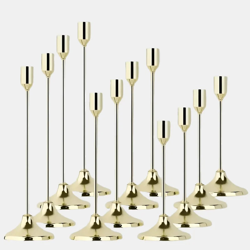 A set of twelve elegant gold metal candle holders for weddings and holiday decor.