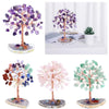 A set of crystal money tree decor featuring purple, pink, and green foliage on natural stone bases.