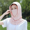 A woman wearing a light pink breathable UV protection balaclava face mask and long neck cover outdoors.
