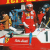 A close-up of a red Ferrari race car with the number 1, featuring sponsors and a driver in racing gear.