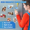 A woman is using a mini magnetic photo frame to display pictures on a refrigerator door.