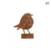 A rustic metal bird sculpture with a brown, weathered finish mounted on a small wooden base.