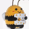 Handmade crochet bee baseball bat doll holding a positivity card