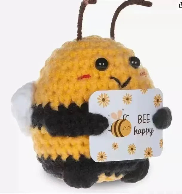Handmade crochet bee baseball bat doll holding a positivity card